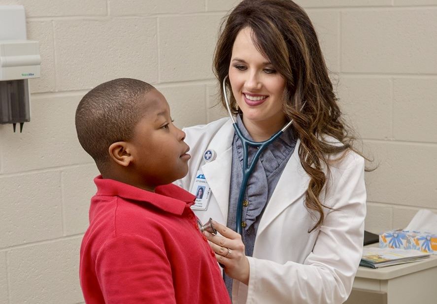  Nurse takes student heartbeat at JCT School Health Clinic.